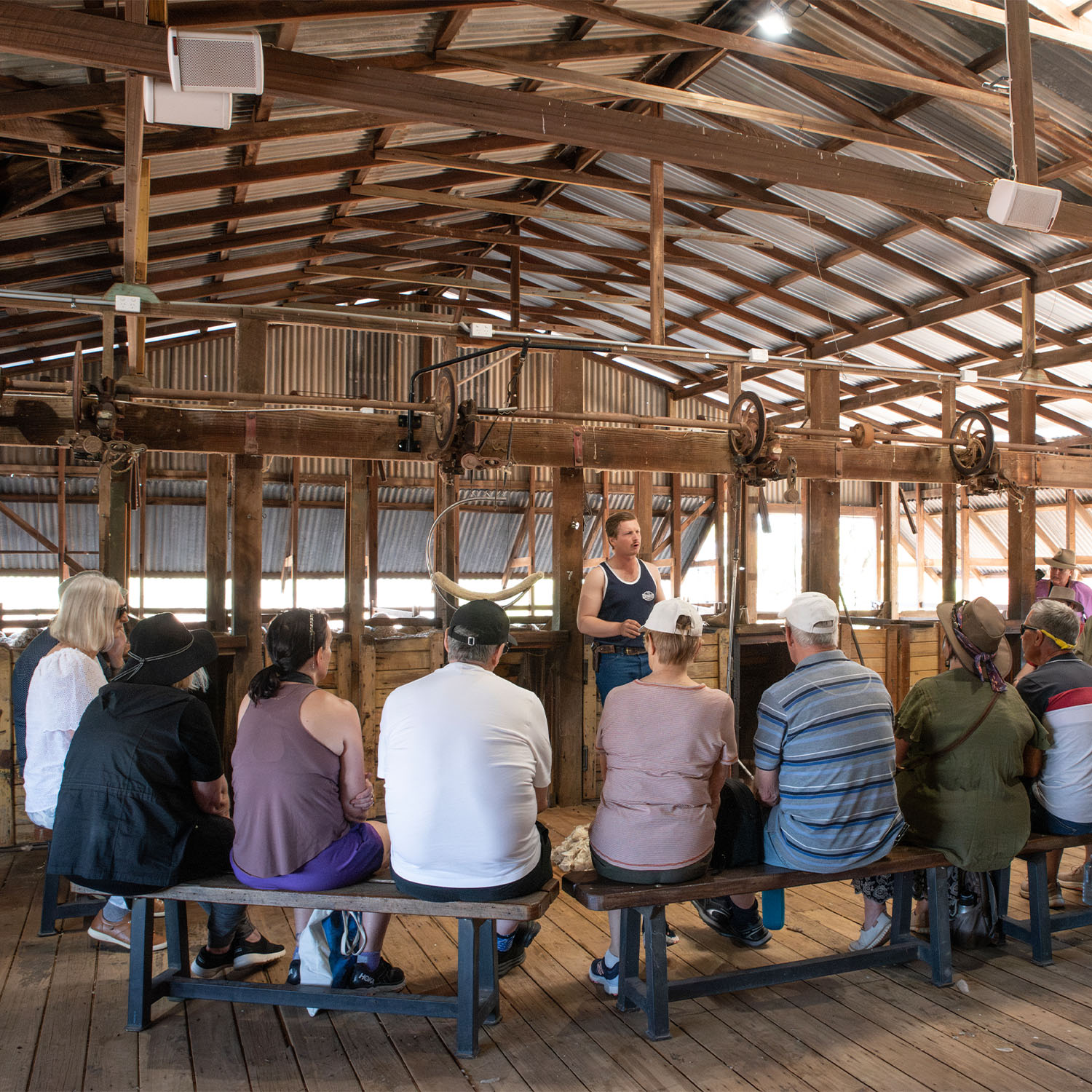 Jeremy Kinnon talking to a group of guests inside the Nogo Shearing Shed